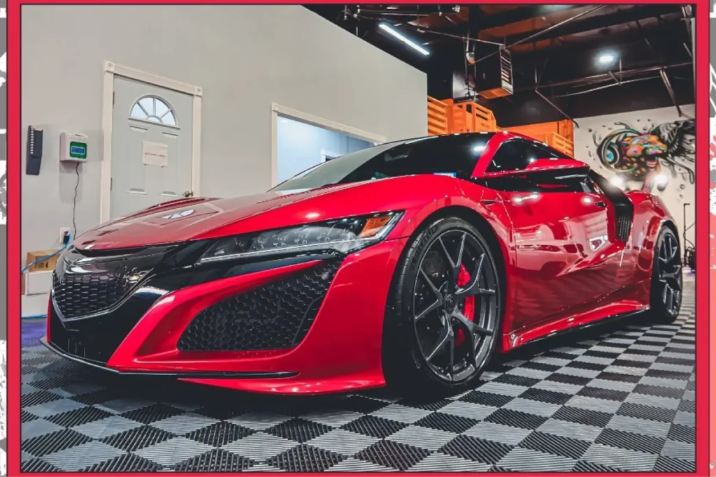 Close-up of a red sports car showing detailed bodywork and custom wheels
