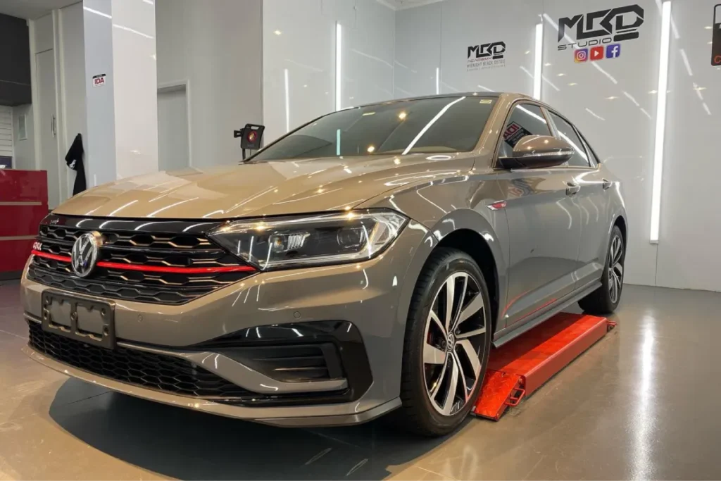 Gray Volkswagen GLI sedan in detailing studio