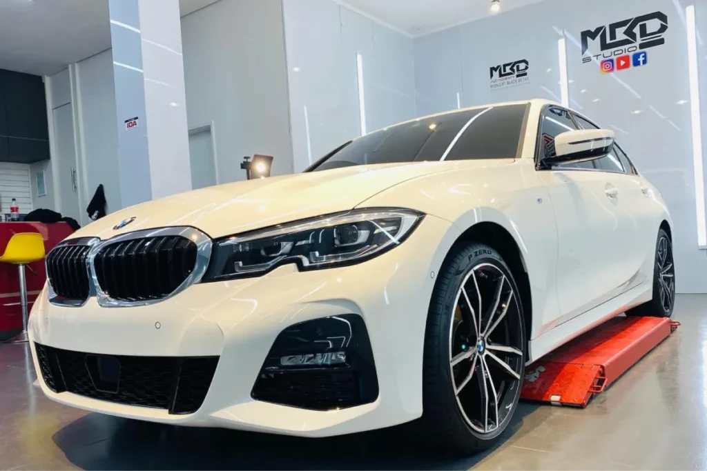 Front view of white BMW after detailing in studio