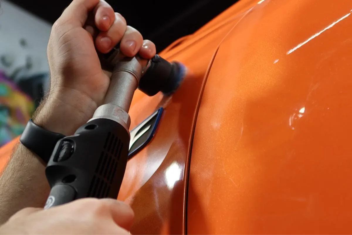 Ceramic coating being applied to orange Lexus paint.