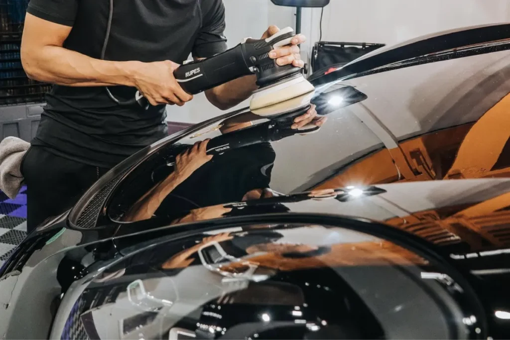 Ceramic coating being applied to a black car for a glossy finish.