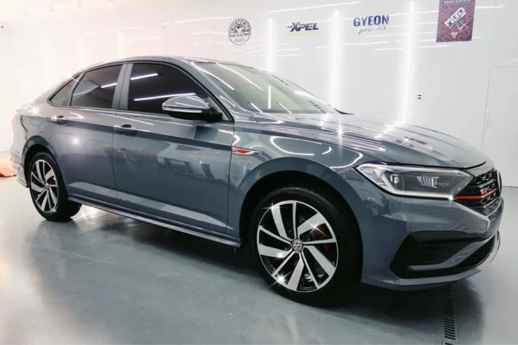 Front view of a Volkswagen sedan with tinted windows.
